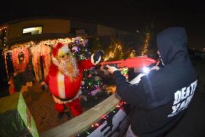 Staff of Death Yard Haunted Attraction demonstrate the Zombie Santa features at their haunted house in Hendersonville